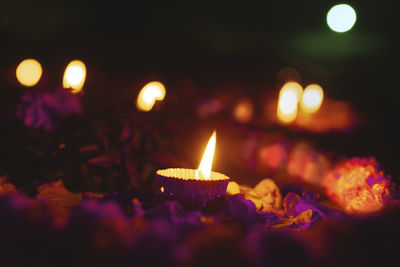 Close-up of lit candles against blurred background