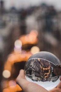 Close-up of hand holding crystal ball