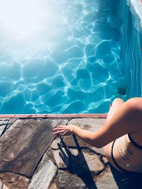 Low section of woman holding swimming pool