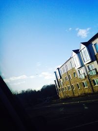 View of buildings against blue sky