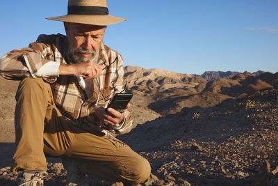 Rear view of man standing against mountain