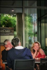 Rear view of couple sitting at window