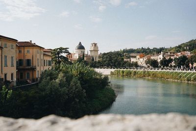 River amidst buildings against sky