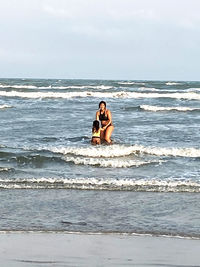 Woman on beach against sea against sky