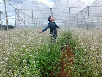 Man standing in greenhouse