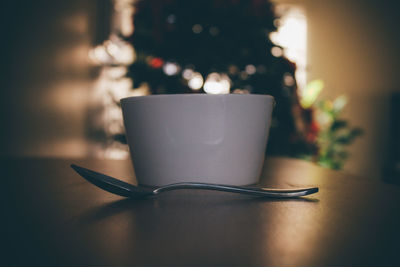 Close-up of coffee cup on table at home