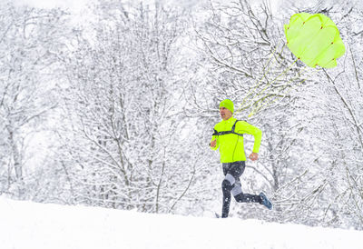 Man walking on snow covered land