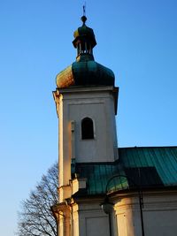 Low angle view of old building against clear blue sky