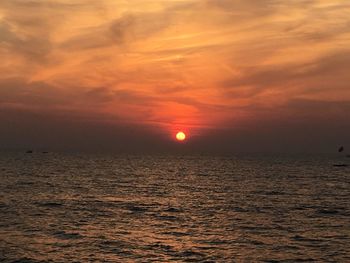 Scenic view of sea against romantic sky at sunset