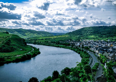 High angle view of river amidst mountains against sky