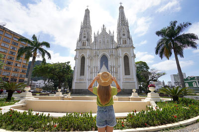 Back view of young traveler woman looking the vitoria cathedral in espirito santo state, brazil.