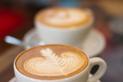 Close-up of two white coffee cups