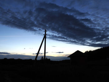 Low angle view of electricity pylon against sky