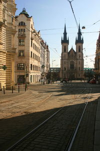 View of city street and buildings against sky