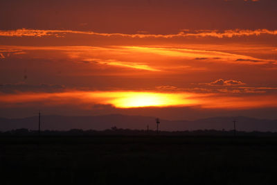 Scenic view of silhouette landscape against romantic sky at sunset