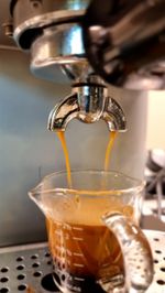 Close-up of coffee pouring into glass