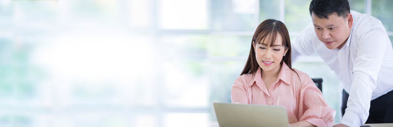 Young woman looking away while using mobile phone