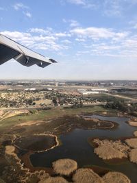 Airplane flying over sea against sky