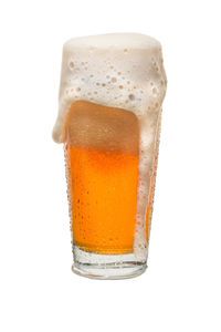 Close-up of beer glass against white background