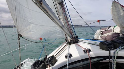 Sailboat sailing on sea against sky