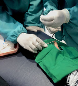 Midsection of doctor examining patient in hospital