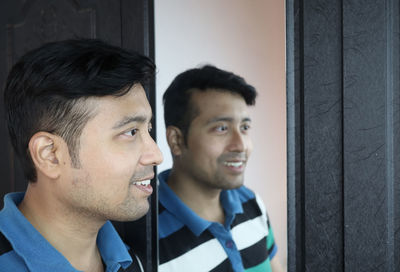 Portrait of smiling young man looking away