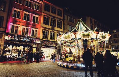 Crowd on illuminated city at night