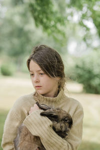 Girl holding rabbit