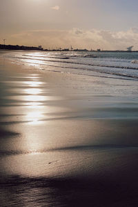 Scenic view of beach against sky during sunset