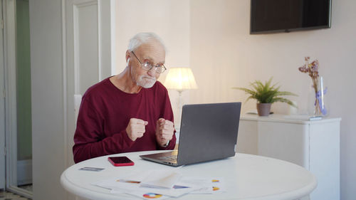 Senior man talking on video call at home