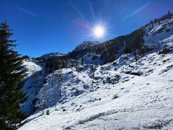 Scenic view of snow covered mountains against sky