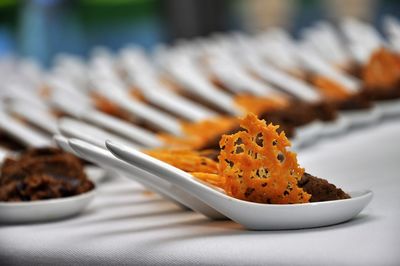 Close-up of desserts on spoons at table