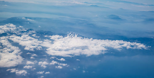 Aerial view of clouds over mountain