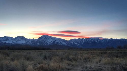 Scenic view of snowcapped mountains against sky during sunset