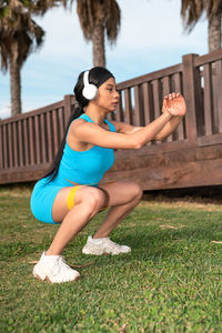 A pretty african american woman doing sports by the beach on a sunny day