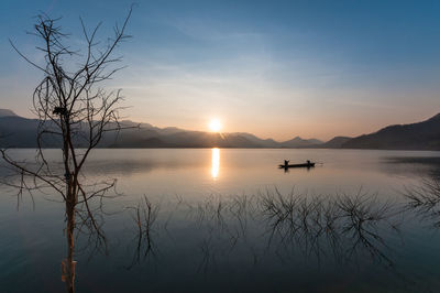 Scenic view of lake against sky during sunset