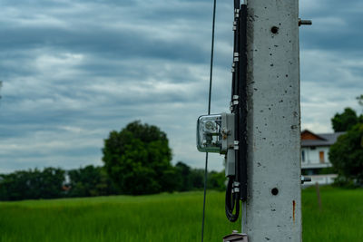 Meter pole on field against sky