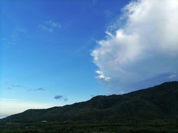 Low angle view of mountains against blue sky