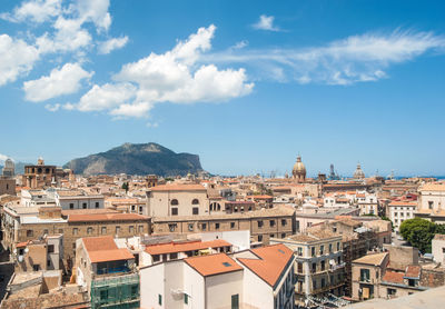 Buildings in town against sky