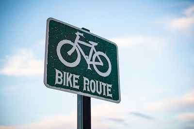 Low angle view of road sign against sky