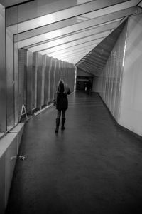 Rear view full length of woman walking at corridor