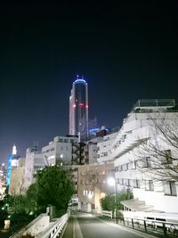 Illuminated cityscape against clear sky at night