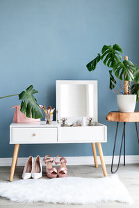 Stylish room interior with elegant dressing table and plants