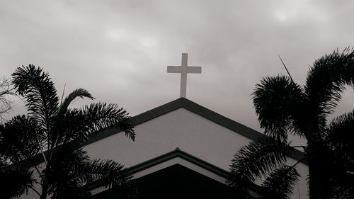 Low angle view of silhouette palm trees against sky