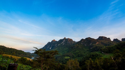 Scenic view of mountains against blue sky