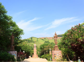 Trees in temple against sky