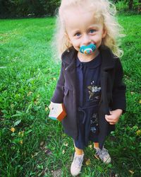 Portrait of boy on grassy field