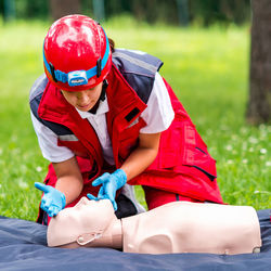 Healthcare worker practicing on cpr dummy at park