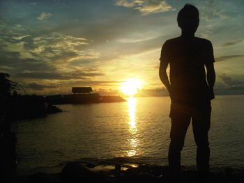 Silhouette of people on beach during sunset