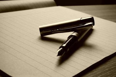 High angle view of pen and book on table 